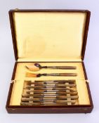 A GOOD BOXED CARVED RHINO HORN HANDLED CUTLERY 29 PIECE SERVICE, in line sectioned box. Circa 1920.