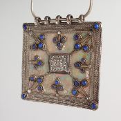 A LARGE ISLAMIC SILVER AND BLUE LAPIZ SQUARE PENDANT on a chain