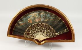 A GOOD 18TH CENTURY FRENCH IVORY AND PAPER FAN in a glass case, with figures dancing in a garden