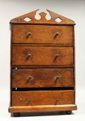 AN APPRENTICES OAK FOUR DRAWER TALLBOY, with arched pediment top, turned wood handles, on bun