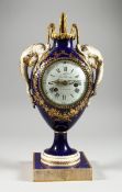 A GOOD LOUIS XVITH STYLE URN SHAPED PORCELAIN CLOCK, blue and gilt decoration. Dolphin handles and