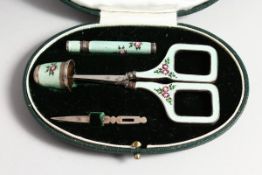 AN ASPREY'S SILVER AND ENAMEL FOUR PIECE MANICURE SET decorated with roses, in an Asprey's case.