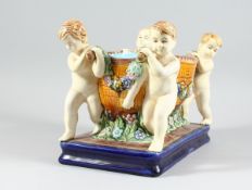 A MAJOLICA MINTON DESIGN POTTERY PLATTER with four cupids