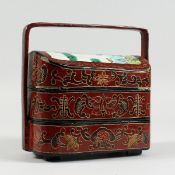 A CHINESE LACQUERED THREE TIERED BASKET.