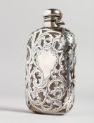A GOOD GLASS AND PIERCED SILVER WHISKY FLASK with scrolled decoration, 5ins long.