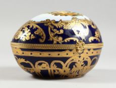 A PORCELAIN BLUE AND GILDED EGG, 8 in.