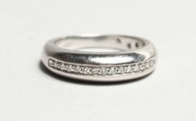 AN 18CT WHITE GOLD HALF ETERNITY RING.