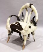 A GOOD HORN ARMCHAIR with cowhide seats.