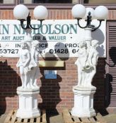 AN EXTREMELY LARGE PAIR OF WHITE COMPOSITION LAMPS, each formed as three classical figures holding