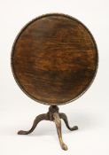 A GEORGE III MAHOGANY CIRCULAR TILT TOP TRIPOD TABLE, with dished top, turned vase shaped column