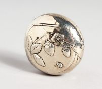 A HAMMERED CIRCULAR SILVER SNUFF BOX repousse with leaves and flowers