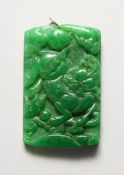 A CHINESE CARVED APPLE GREEN PENDANT 2.5 ins