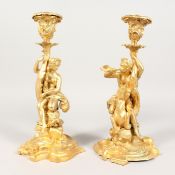 A GOOD PAIR OF GILT BRONZE CLASSCIAL FIGURAL STICKS on shaped bases. 11 ins high.