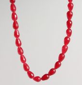 A STRING OF CHERRY AMBER BEADS