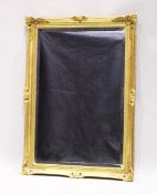 A GILT FRAMED UPRIGHT BEVELLED MIRROR, 3 ft. 5 in. high, 2 ft. 5 in. wide.