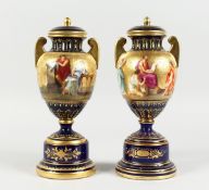 A SUPERB PAIR OF VIENNA TWO HANDLES VASES AND COVERS, rich blue and gilt grounds painted with a band