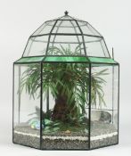 A TERRARIUM with plastic flowers 1 ft. 5 in. high