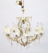 A GOOD ITALIAN GLASS TWELVE LIGHT CHANDELIER with prism drops 2 ft. 4 ins wide, 2 ft high.