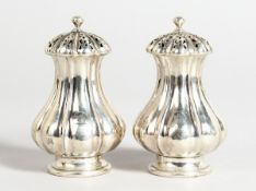 A PAIR OF SILVER FLUTED PEPPERETTES