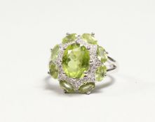 A SILVER PERIDOT CLUSTER RING