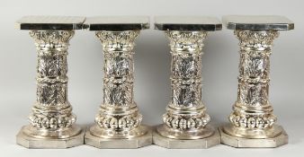 A SET OF FOUR SILVERED SQUARED TOP STANDS on octagonal bases, 15.5 in. high.