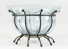 A TINTED SHAPED GLASS BOWL on a wrought iron stand, 13 ins diameter.