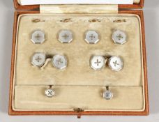 A SET OF PLATINUM AND MOTHER OF PEARL STUDS AND CUFF LINKS Goldsmith & Silversmith Co. Provenance: