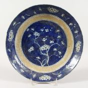A CHINESE PRUNUS PATTERN BLUE AND WHITE DISH 11 ins diameter.