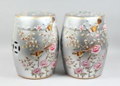 A PAIR OF CHINESE SILVER BARREL SEATS with peonies 17 ins high