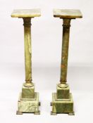 A PAIR OF ONYX AND ORMOLU PEDESTAL COLUMNS, with revolving square tops, plain turned column on a
