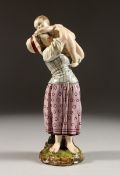 A GOOD HOCHST POTTERY FIGURE OF A MOTHER AND CHILD. Hochst Mark No. 157. 9ins high.