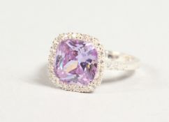 A SILVER, PINK STONE AND CZ CLUSTER RING