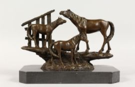 A BRONZE GROUP OF THREE HORSES on a marble base. 10 ins long.
