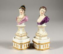 A GOOD SMALL PAIR OF DRESDEN BUSTS ON FIXED STANDS of a man and woman. Crossed swords mark in