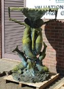 A LARGE CAST IRON WATER FEATURE as two mermaids and a dolphin on a scroll base. 5 ft high.
