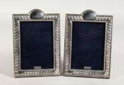 A PAIR OF SCROLL DECORATED PHOTOGRAPH FRAMES, 7 ins x 5 ins.