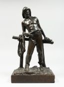 P. KOMDLEZEUSKI A BRONZE OF A FISHERMAN standing in front of a fence, signed, 12 ins high on a