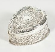 A VICTORIAN SILVER HEART SHAPED BOX repousse with flowers and scrolls Birmingham 1899.