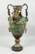 A BRONZE TWO HANDLED URN with cupid, acanthus scroll and laurel leaf handles, 2 ft. 8 in high.