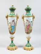 A GOOD PAIR OF SEVRES DESIGN TWO HANDLED VASE AND COVER painted with cupids, 27 ins high.