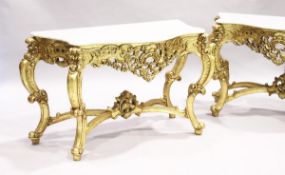 A PAIR OF GILDED AND MARBLE TOP CONSOLE TABLES with white speckled marble tops, gilt bases with
