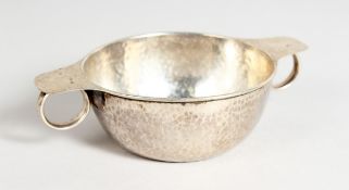 A LIBERTY & CO. CIRCULAR SILVER HAMMERED TWO HANDLED BOWL 4 ins high Birmingham 1910