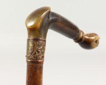 A GOOD 19TH CENTURY WALKING STICK with carved RHINO HANDLE, as an arm and clenched fist, with