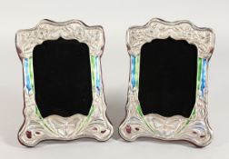 A GOOD PAIR OF SILVER AND ENAMEL PHOTOGRAPH FRAMES with butterflies 8 is x 6 ins