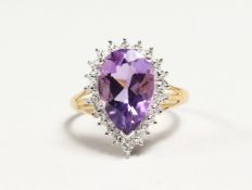 A SILVER GOLD PLATED PEAR SHAPED AMETHYST RING