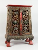 A CHINESE LACQUERED CABINET with mosaic inlaid doors and pierced decoration, 2 ft. 2in. high.