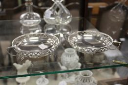 A pair of silver twin handled bonbon dishes with pierced sides.