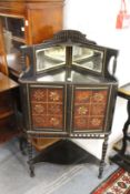 An Aesthetic movement ebonised and parcel gilded corner cabinet.