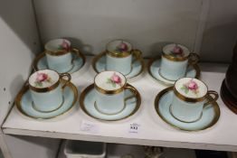 A set of six Paragon china coffee cans and saucers, pale blue ground with rose decorated interiors.