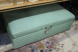 An upholstered box ottoman.